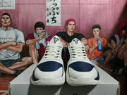 Front view showing white laces, navy perforated toe panels, and black-and-white tongue graphics.