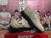 Angled view of the beige and black Nike Air Max sneaker pair displayed on a red shoebox.