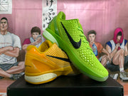 Yellow and bright green Nike basketball shoes shown together, both with textured uppers and black Swoosh logos.