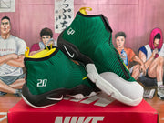Angled view of paired green Nike basketball sneakers showing the patterned upper, black and white sole, yellow accents, and number 20.