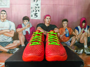 Front view of the red basketball shoes with bright green laces and textured uppers.