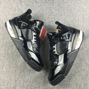 Top-down view of a pair of black high-top sneakers with mesh panels and decorative hangtags.