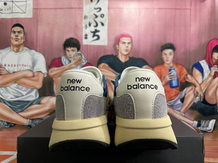 Rear view of blue, yellow, gray, and off-white New Balance U370 sneakers