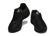 Front three-quarter view showing the black laces, textured toe boxes, and silver tongue emblems.