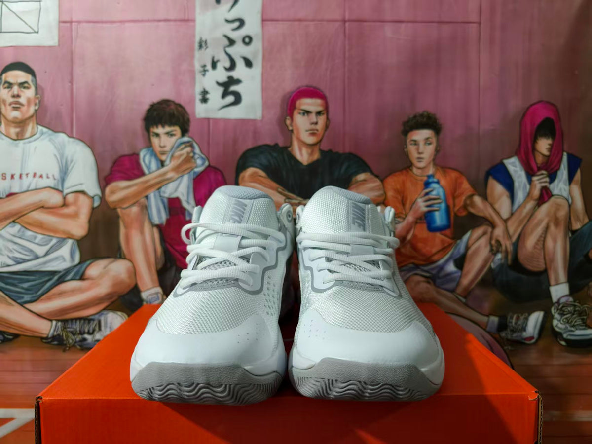 Front view of white and grey Nike sneakers on an orange box