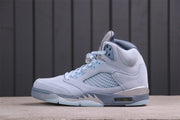 Side profile of the light icy blue Jordan Air Jordan 5 Retro sneaker with a mesh panel, silver midsole accents, and translucent outsole.