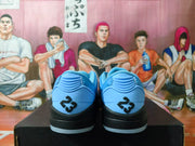 Rear view of blue sneakers with raised black heel emblems