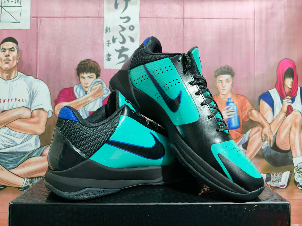 Black and teal Nike Kobe basketball shoes shown at an angle