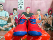 Front view showing the red textured uppers, blue laces, and blue toe outsole accents.