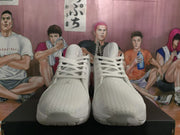 Front view of the white Jordan sneaker pair showing lace-up closures, textured uppers, padded collars, and rounded toe boxes.