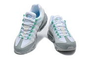 Front view of a pair of white, grey, and green Nike Air Max 95 TT sneakers