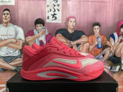 Side profile of the pink basketball sneaker with a contrasting light side panel and solid pink outsole.