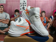 White ASICS Sky Elite FF 3 shoes arranged at an angle, showing orange side detailing