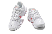 Front views of a pair of white sneakers with red accents and lace-up fastening.