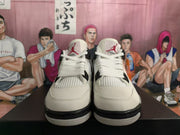 Front view of white and grey high-top sneakers with black accents and Jumpman tongue logos