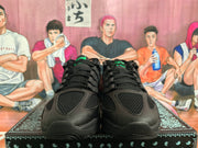 Front view showing black mesh toe panels, laces, and green tongue accents