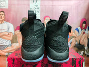 Rear view showing heel branding, textured heel panels, and pull loops.