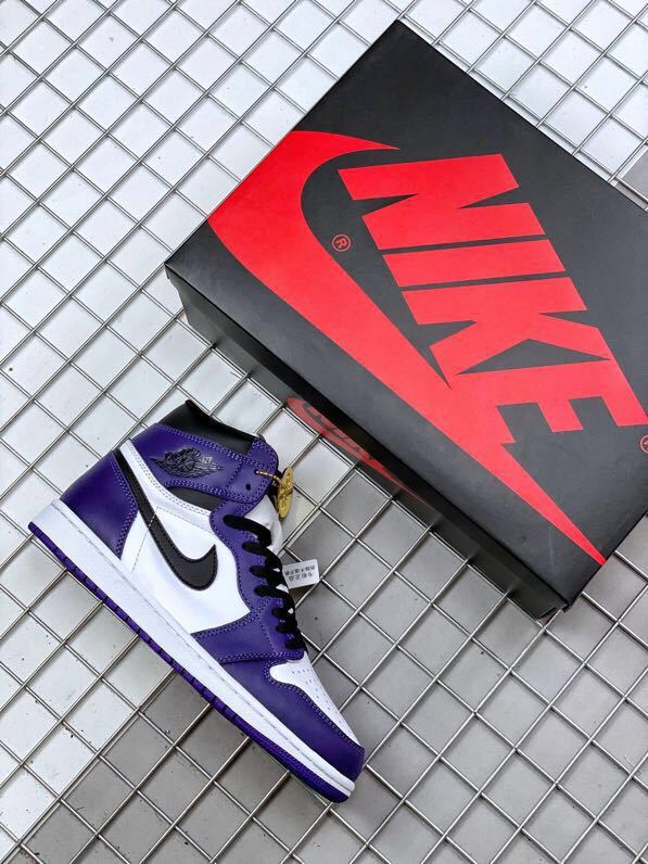 Purple and white high-top sneaker shown beside a black and red shoebox.