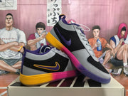 Angled side view highlighting the Nike swoosh, gray overlays, purple collar, and multicolor outsole.