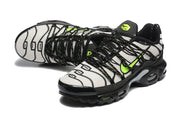 Angled view of the patterned Nike Air Max Plus sneakers