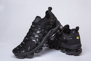 Black Nike-style sneakers shown in crossed side and heel views.