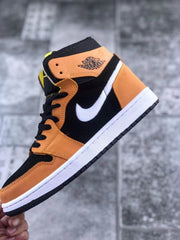 Close side profile showing the orange ankle panel, winged basketball emblem, white Swoosh, and black upper.