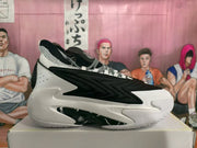 Side profile of one black-and-white basketball sneaker showing the low-cut shape, layered side detailing, and textured outsole.