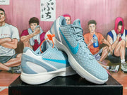 Pair of light blue Nike Kobe basketball shoes shown at an angle
