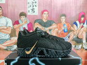 Side view of a black Nike sneaker with a gold-tone Swoosh and textured outsole