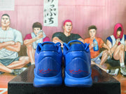 Rear view of blue Nike Kobe shoes with red signature-style heel details.