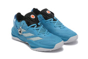 Angled view of a pair of blue shoes with black tongues and light-colored side stripes