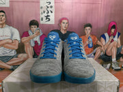 Front view of gray and blue Nike basketball sneakers with blue laces, blue tongues, and white tongue graphics.