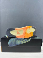 Underside view of the sneaker showing a segmented outsole in dark gray, pale yellow, and translucent orange with a Jordan logo.