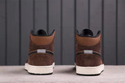 Rear view showing the brown heel panels, black trim, white midsoles, and black outsoles.
