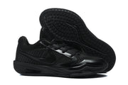 Black Nike 518-6 sneakers shown from the side with one shoe lifted to display the patterned outsole.