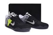 Black and white basketball shoes displayed in front of a black box