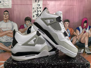 Angled view of a pair of white and black high-top sneakers displaying the layered upper, mesh side panels, grey overlays, and contrasting midsoles.
