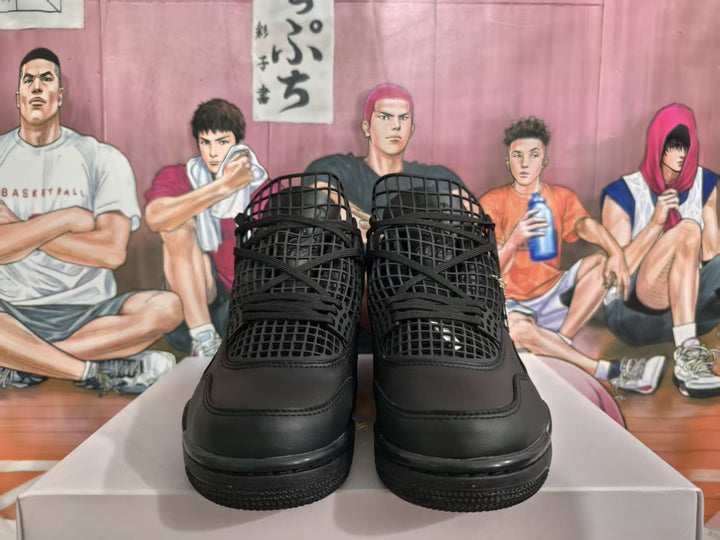 Front view of black high-top sneakers with grid-style panels, black laces, and tonal branding details.