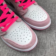 Close-up of the white perforated toe box, pink overlay and bright pink laces.