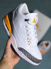 Angled view of a white Jordan 3-style sneaker with orange details and elephant-print overlay.