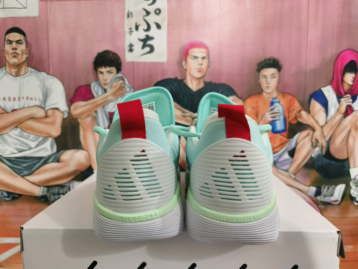 Rear view of mint-green basketball sneakers showing white heel panels and red pull tabs.
