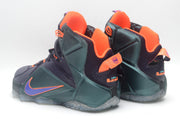 Pair of black and dark green high-top basketball sneakers with purple and orange accents, shown from the side and rear.