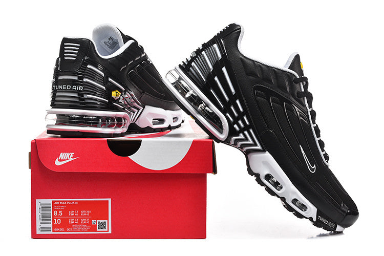 Black and white Nike Air Max Plus III sneakers displayed with a shoe box