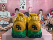 Heel view showing a dark emblem and green midsole