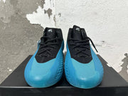 Front view showing black laces and bright blue toe and sole detailing