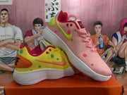 Angled view of the mismatched yellow and pink sneakers displayed together, showing their contrasting side details and laces.