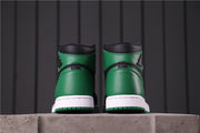 Rear view of the pair showing green heel panels, black collars, white midsoles, and green outsole edges.