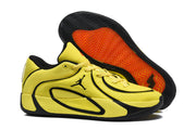 Side and outsole view showing the yellow upper, black trim, and patterned rubber tread.