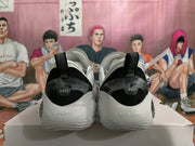 Rear view of white and black Wade basketball shoes with heel branding