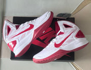 Angled view of the pair highlighting the patterned uppers and red outsoles.